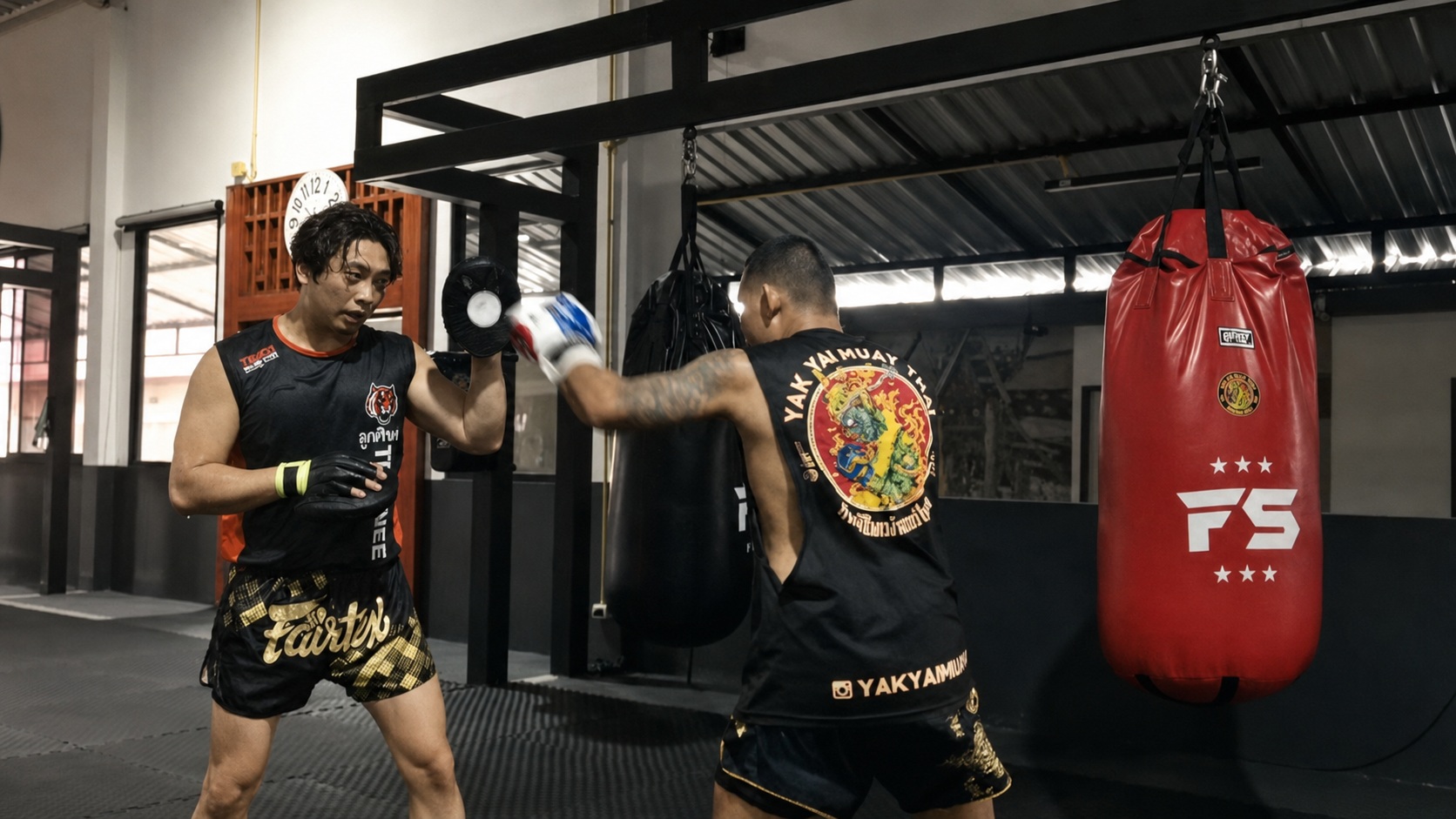 Coach Ben practising combinations with a trainer in Thailand